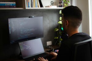 The laptop screen displaying code or programming text