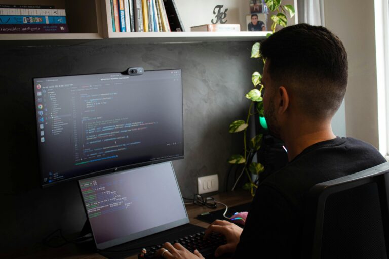 The laptop screen displaying code or programming text