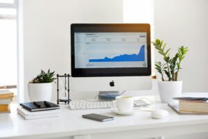 Data-Driven Decision Making: The desktop computer screen shows an infographic, suggesting this workspace is utilized for data analysis and visualization to support informed decision-making processes.